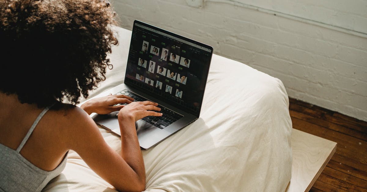 Connection time at Nassau from/to Europe to/from a Bahamasair domestic flight - Black woman working on laptop in bedroom