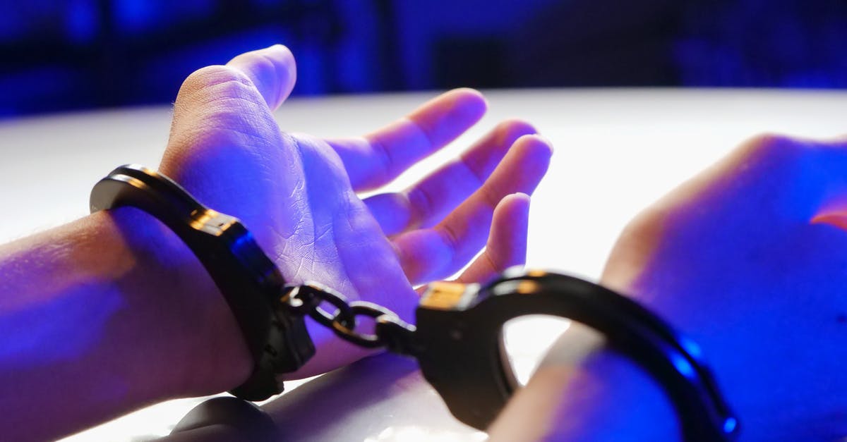 Consequences of being arrested by mistake in the USA - Person Wearing Black Leather Bracelet