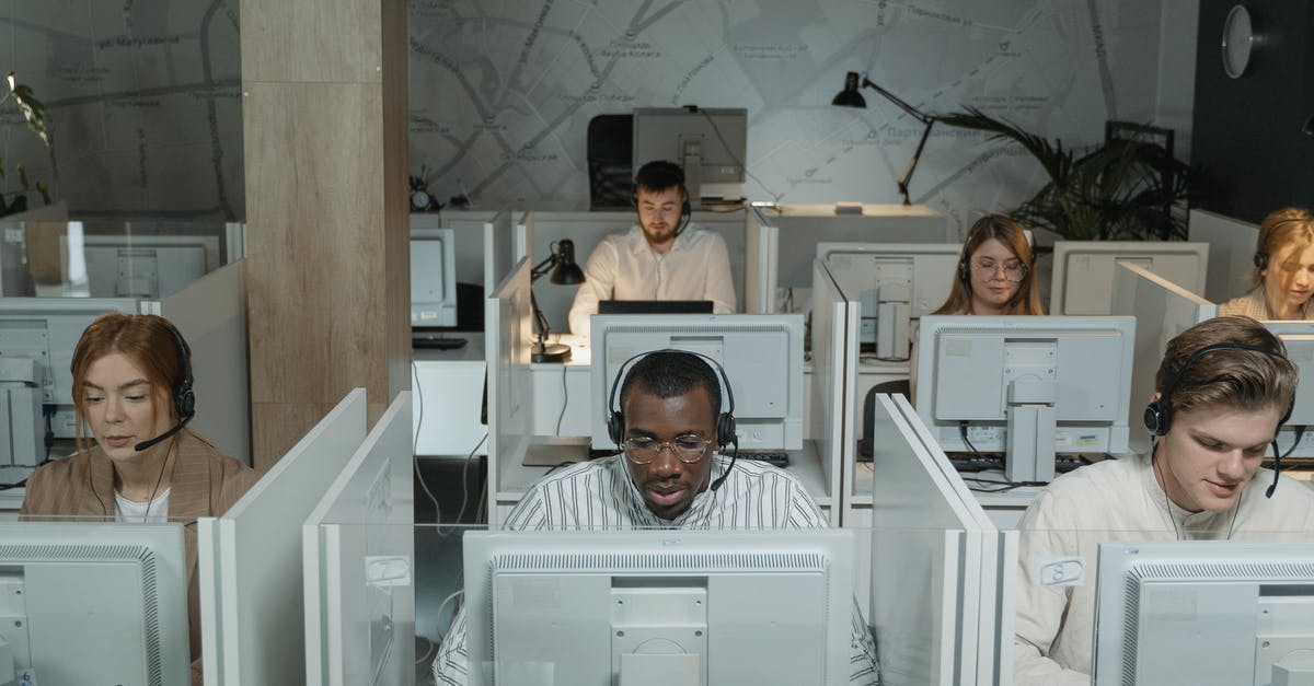 Consular assistance for Australians in Crimea - Man in Black and White Striped Dress Shirt Sitting in Front of Computer