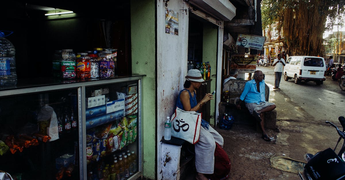 Convenience stores in India - Asian people on street in poor city district