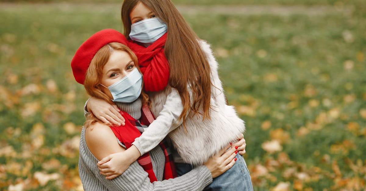 Coronavirus affected co-passenger; what to do? - Girl Hugging Woman In Gray Sweater