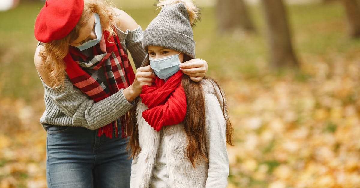 Coronavirus affected co-passenger; what to do? - Woman in Gray Knit Cap Carrying Baby in Red and White Striped Long Sleeve Shirt