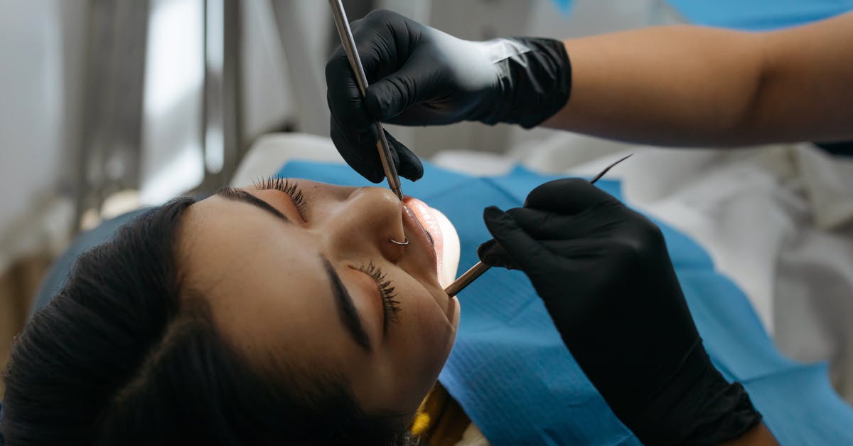 Cosmetic/Dental Surgery in Thailand - Resources? [closed] - Close-up Photo of Dentist Examining Patient's Teeth 