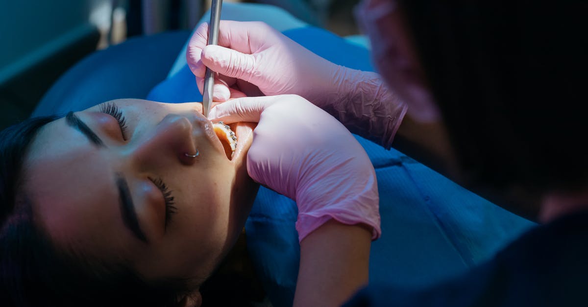 Cosmetic/Dental Surgery in Thailand - Resources? [closed] - Close-up Photo of Dentist Examining Patient's Teeth