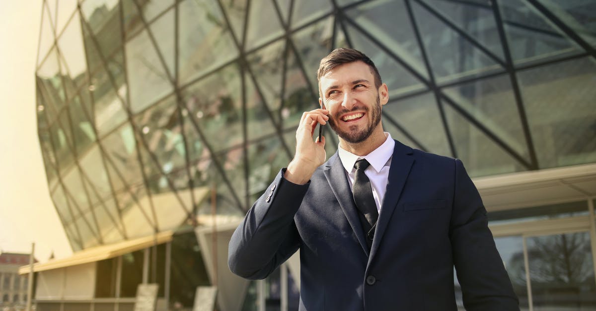 countries to travel using albanian residence permit - Man in Black Suit Jacket While Using Smartphone