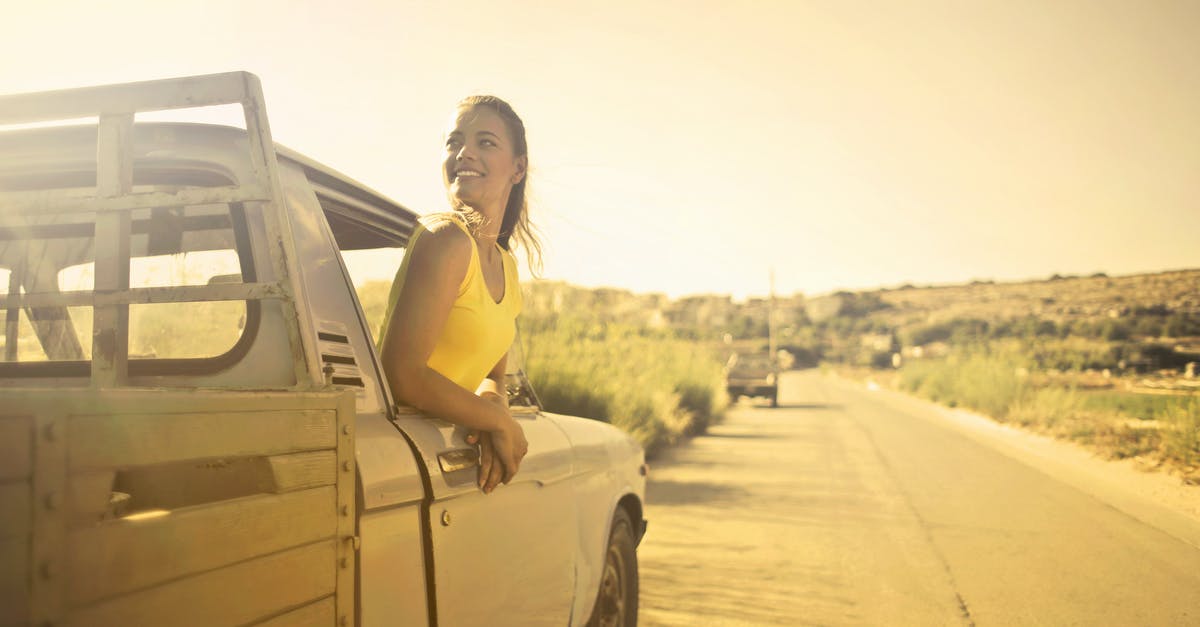 Country sticker necessary on car when visiting the UK? - Woman Wearing Yellow Shirt Inside Pickup Truck