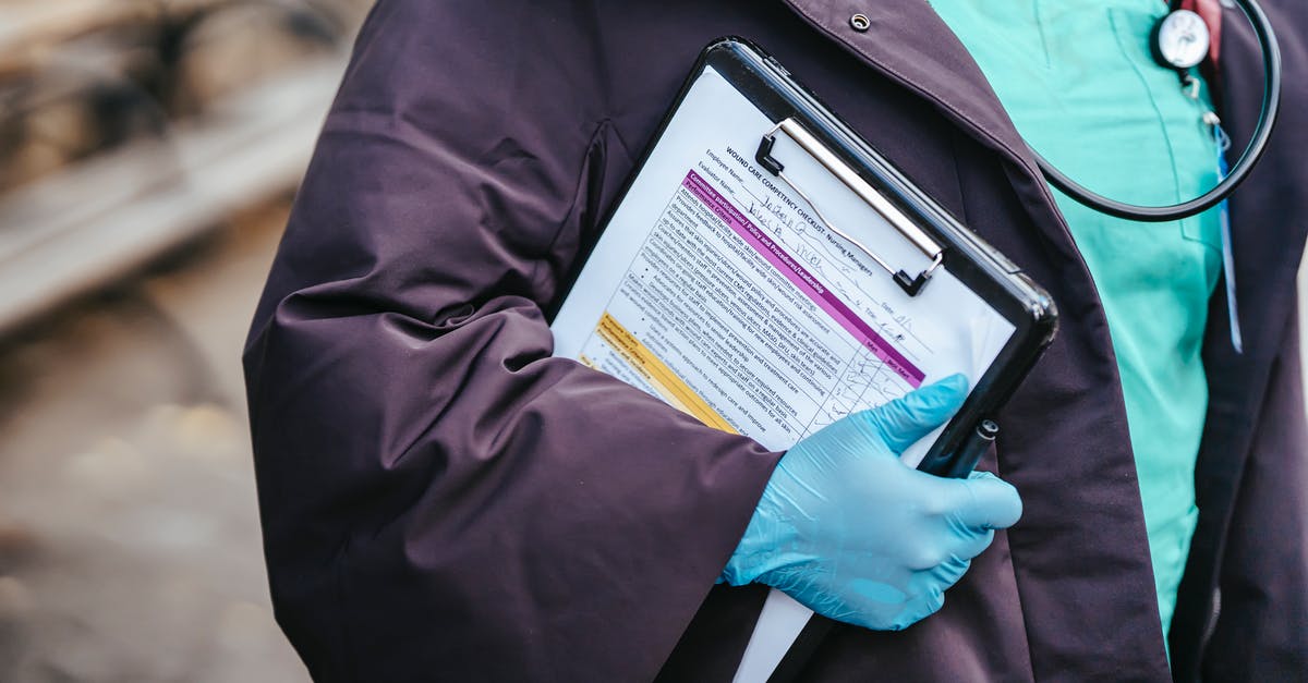 Covid-19 virus day by day chart? [closed] - Crop anonymous female doctor in medical clothes and gloves with stethoscope standing outside with documents in clipboard