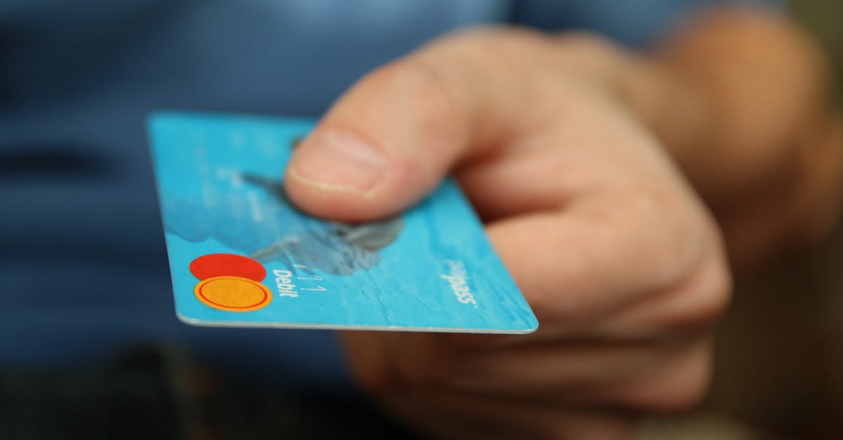 Credit cards in irish gas stations - Person Holding Debit Card