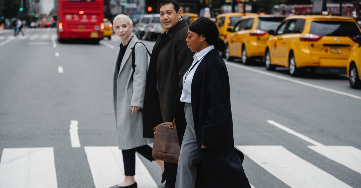 Cross Border Work Visa Requirement? - Positive multiethnic businesspeople crossing road in downtown