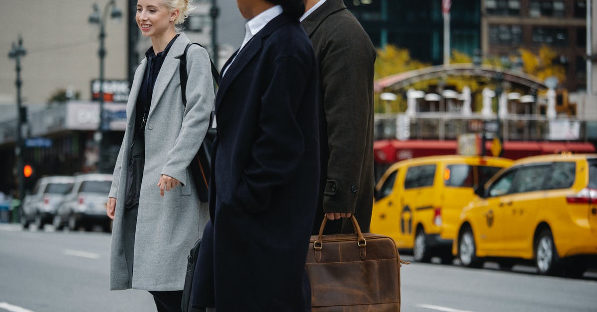 Cross Border Work Visa Requirement? - Cheerful diverse colleagues crossing road in downtown