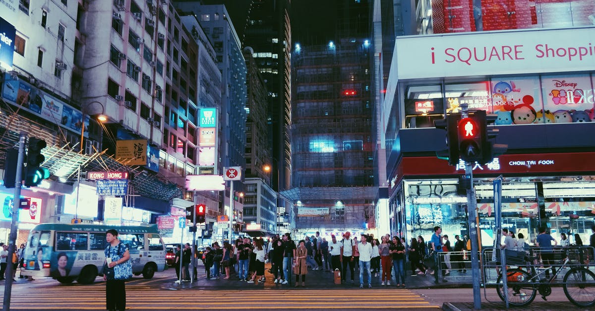 Cross link of Hong Kong passports - People Walking on Pedestrian Lane during Nighttime