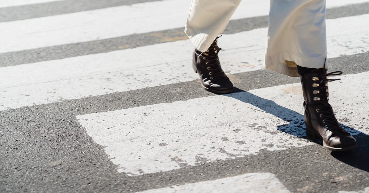 Cross mark on a visa stamp - Bahamas - Woman crossing asphalt road on zebra