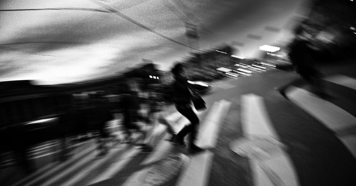 Cross mark on a visa stamp - Bahamas - Black and white of anonymous pedestrians crossing asphalt road on zebra in city