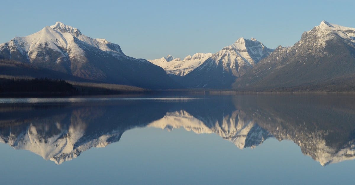 Cross US-Canada border at Glacier NP - Scenic View of Lake and Mountains Against Sky