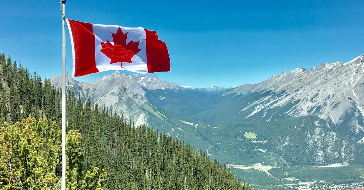 Cross US-Canada border at Glacier NP - Canada Flag With Mountain Range View