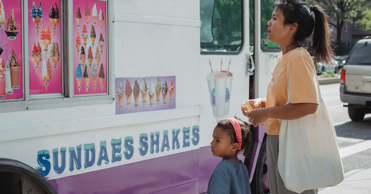 Crossing a border with an infant of a different citizenship - Asian mother with little adorable daughter choosing ice cream