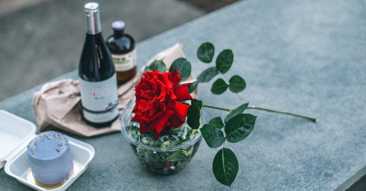 Crossing border from India to Myanmar - Composition of red rose placed on parapet near champagne bottle