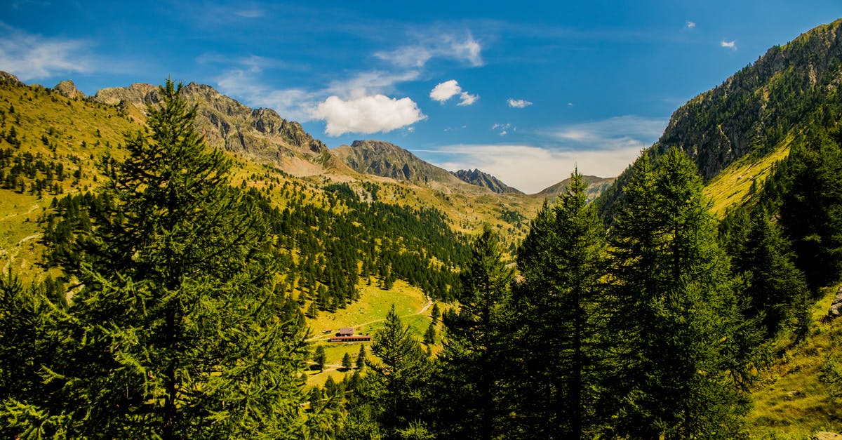 Crossing France-Spain border by hiking trail - possible problems - High Angle Shot Of Tall Green Trees On Mountain Slopes  Under Blue Sky