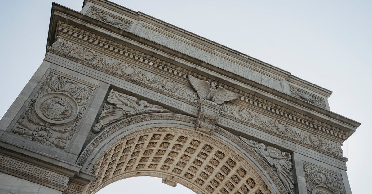 Crossing from US to Canada at the Peace Arch on foot - From below of aged architectural monument with ornamental columns and arched passage located in Washington Square Park