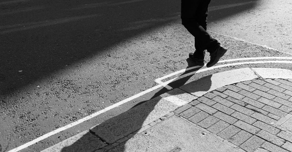 Crossing Swiss-Austrian border by foot - A Person Crossing the Street