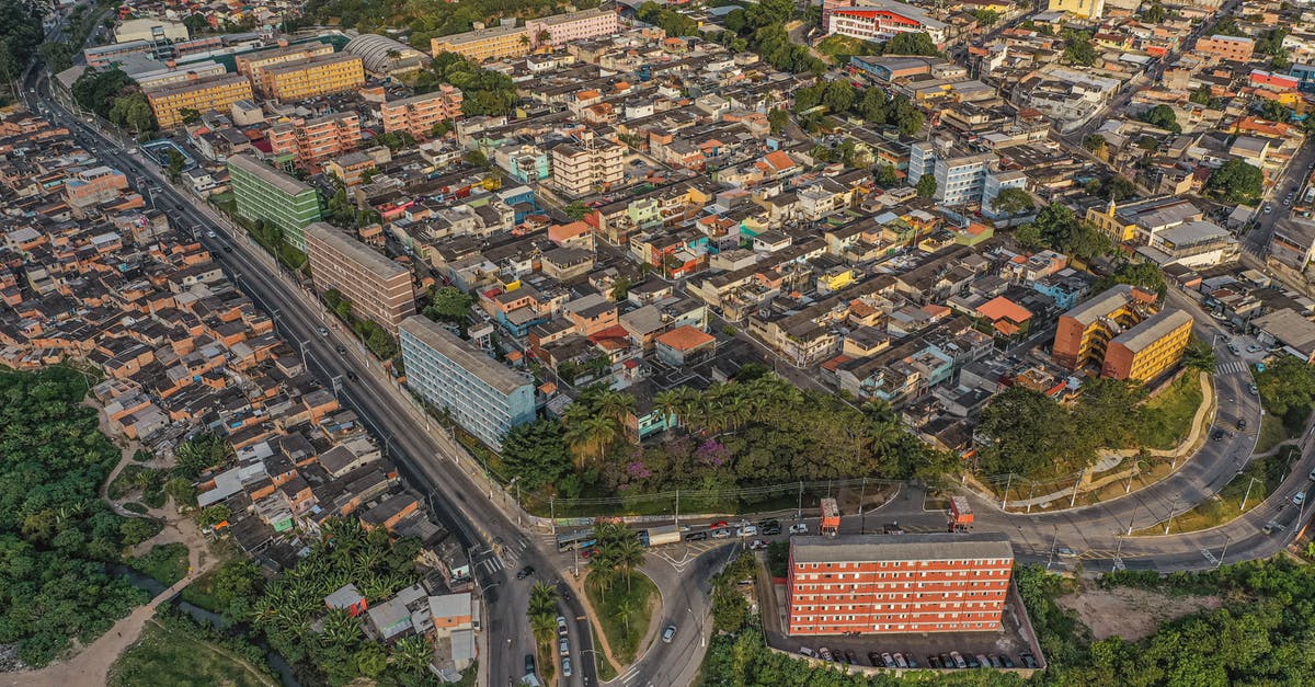 Crossing the Amazon, route 319 - Drone view of residential houses located amidst lush green trees growing on street with crossroad in modern district of city