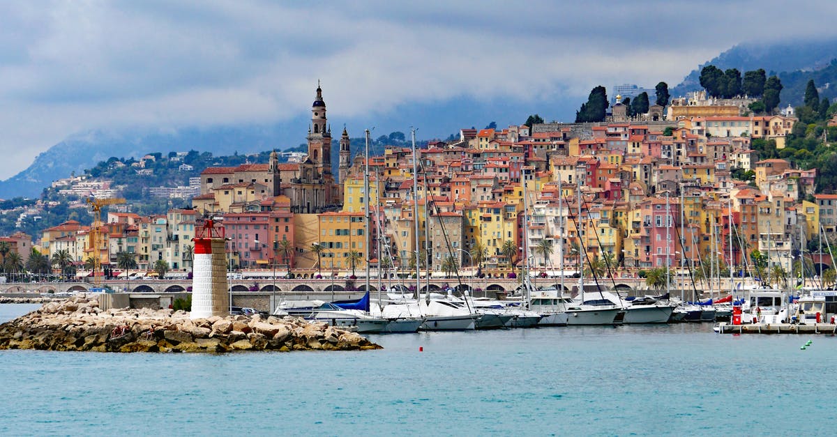 Crossing the border from Switzerland to France and back - Houses Near With Sea With Sailboats and Lighthouse during Daytime