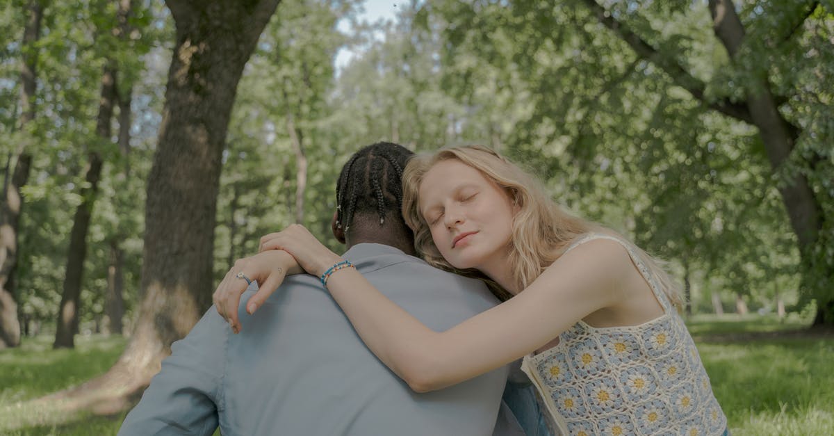 Crossing the border from Switzerland to France and back - Woman Hugging a Man in the Park