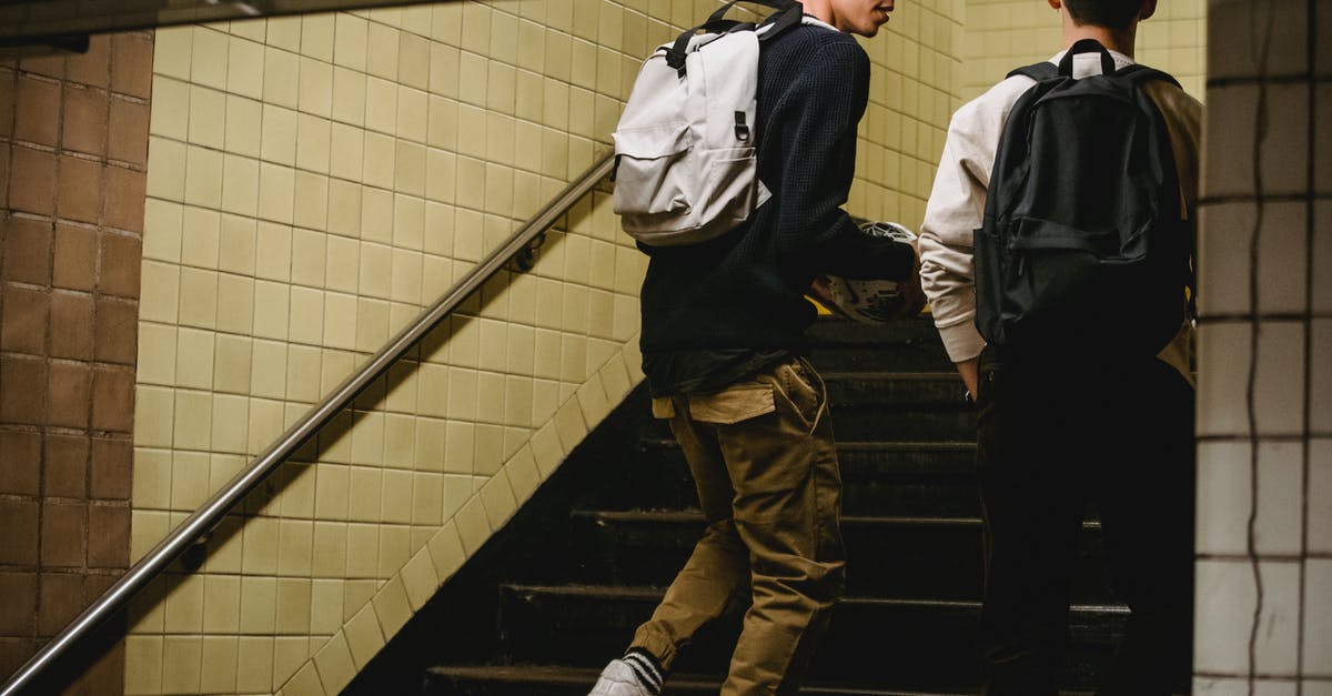 Crossing the US-Canadian border and back - Crop male friends going upstairs in underground passage