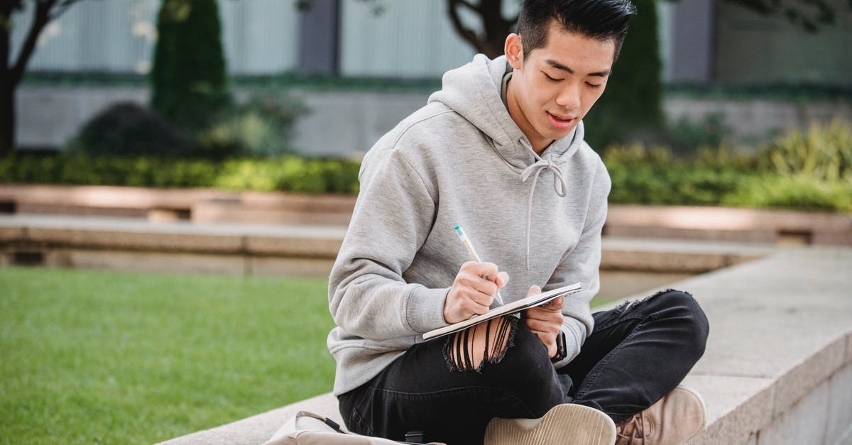 Crossing US/Canada Border for less than 24 hours - Ethnic man taking notes in notebook