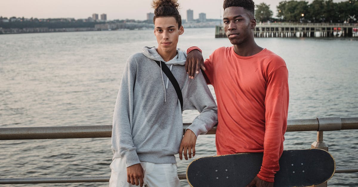 Cruise on Douro river. When is the best time, and the desirable time extension? - Confident multiethnic friends with skateboard leaning on fence while standing on embankment near wide river during free time together