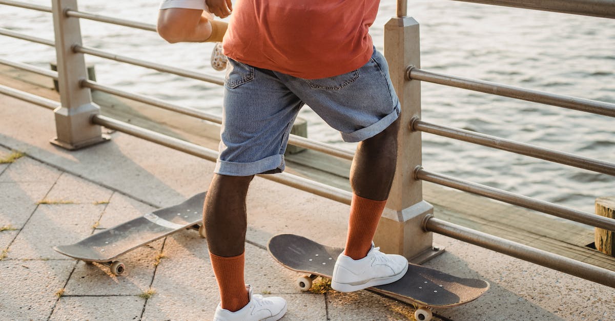 Cruise on Douro river. When is the best time, and the desirable time extension? - Unrecognizable multiethnic male skater standing near embankment railing with skateboards