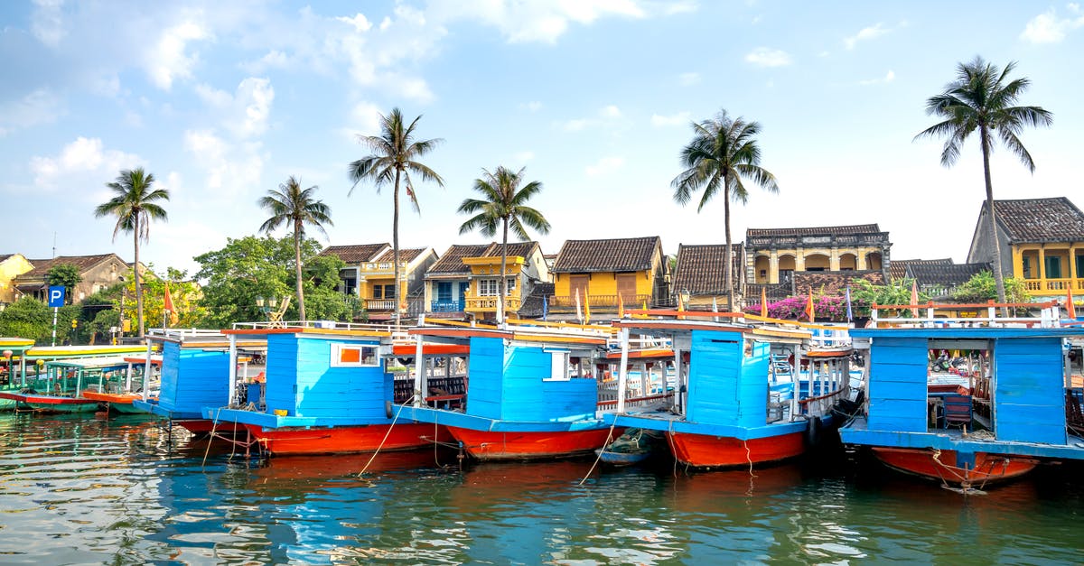 Cruising to Vietnam - Boats moored on river embankment near old town of Hoi An