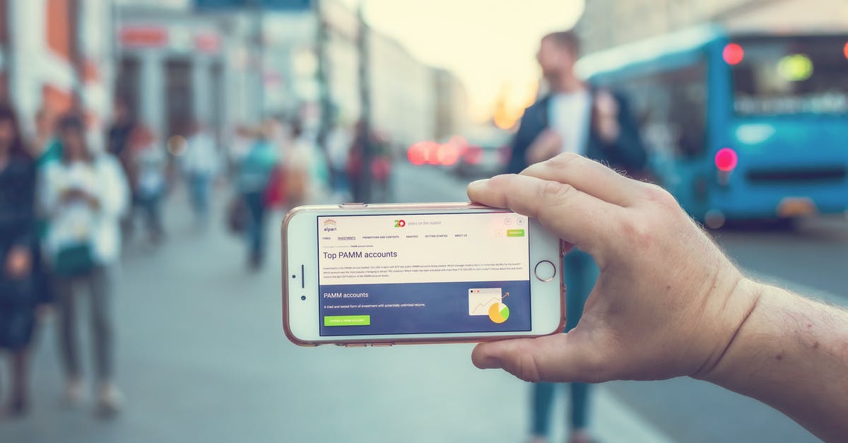 Cuban currency exchange - ATM vs exchange office - A Person Holding a White and Gray Smartphone