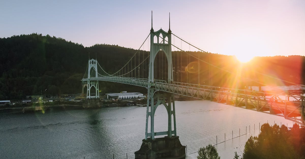 Current state of St Thomas and St John after hurricanes [closed] - Magnificent scenery of aged St Johns Bridge crossing rippling river surrounded by hills with lush green woods against cloudless sunset sky in Portland