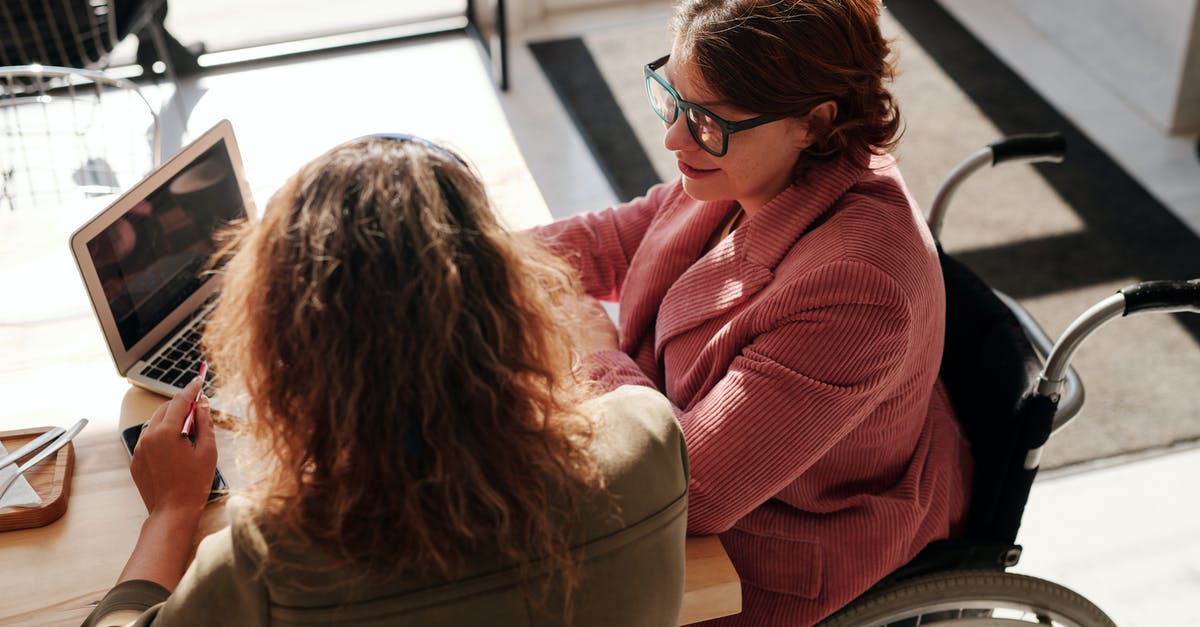 Customs duty for bringing two laptops into France - Woman in Red Sweater Wearing Black Framed Eyeglasses Sitting on Wheelchair