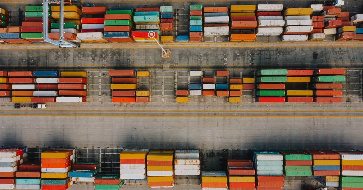 Customs in various airports and Duty Free International Area Detailed - Drone view of various colorful cargo containers placed in rows on asphalt in daytime