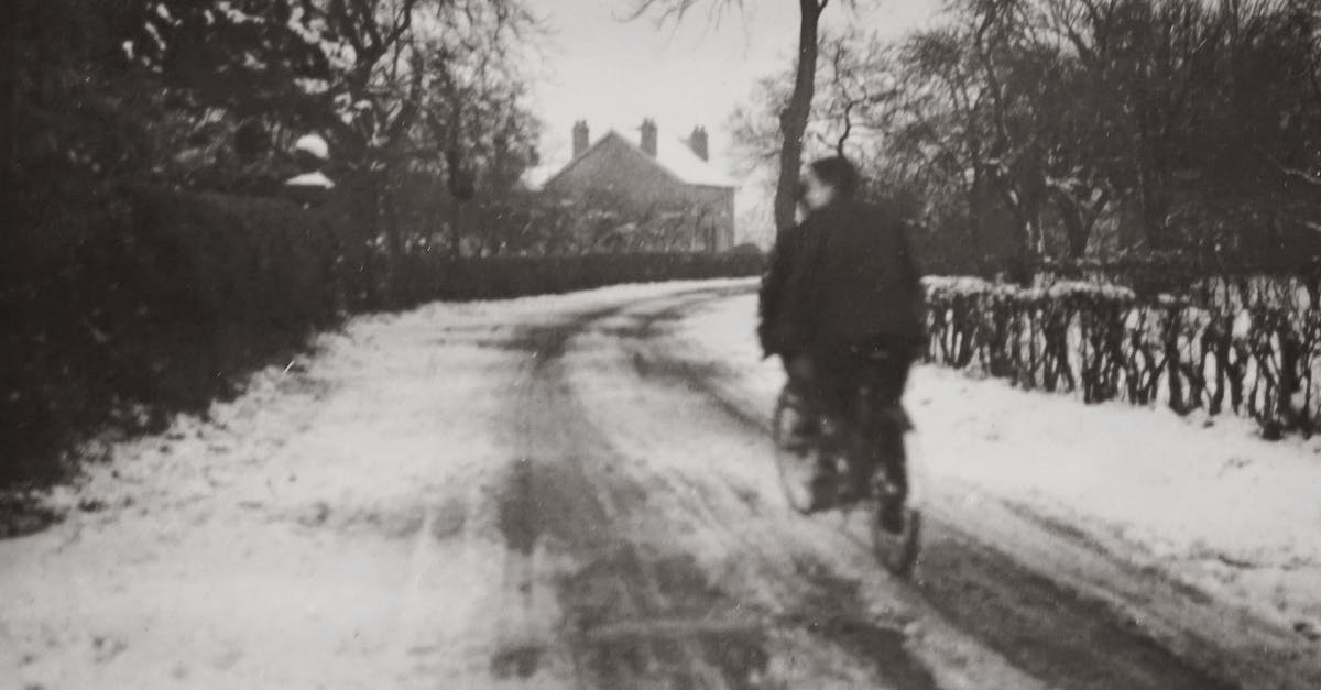 Cycling in Berlin during winter [closed] - Grayscale Photography of Boys Riding a Bicycle On A Snow Covered Road