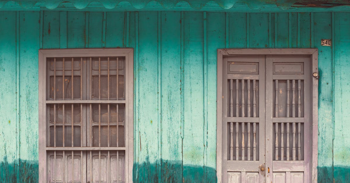 Damaged Indian passport - Blue Wooden Window Frame on White and Brown Concrete Wall