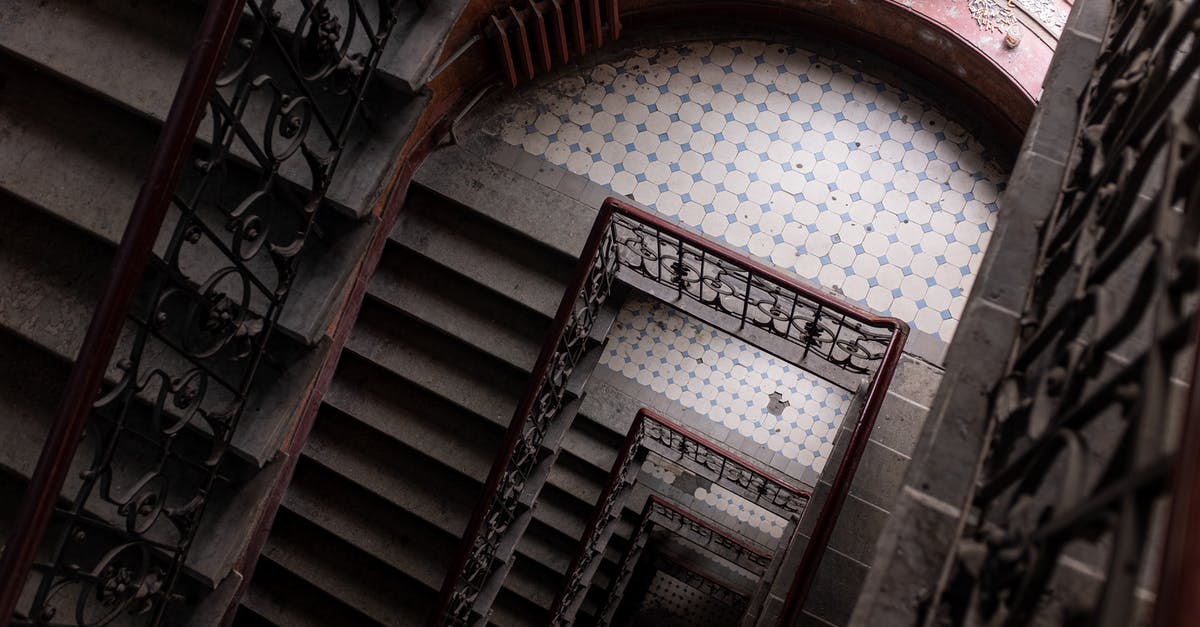 Damaged Luggage on Vueling Flight, how can I proceed? - Brown Wooden Spiral Staircase With White Wall