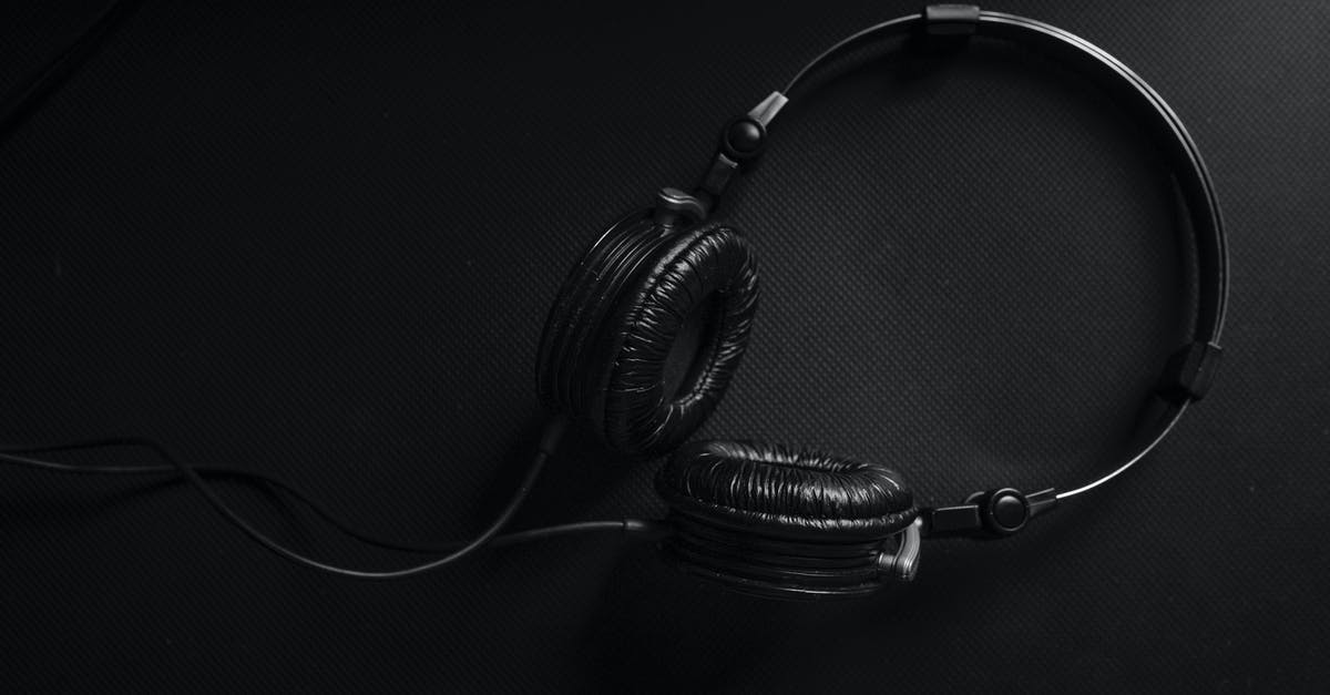 Dark Days in Scandinavia - Black and Silver Headphones on Black Surface