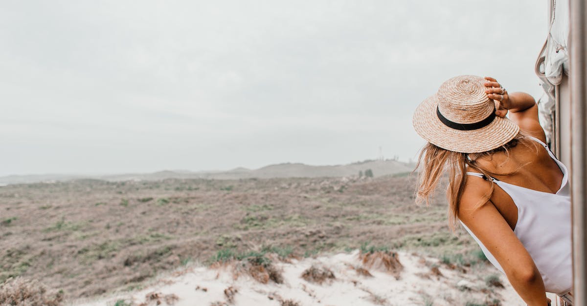 Dealing with smelly travel daypacks? - Woman in Straw Hat Looking at Desert Lands