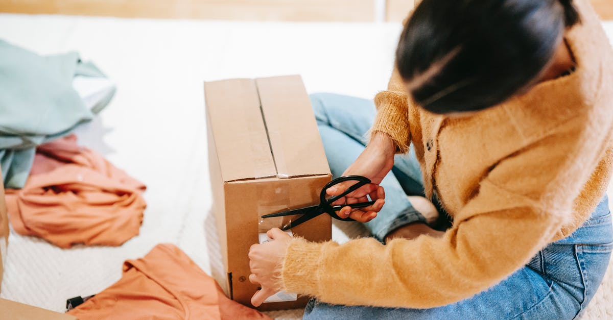 Declare an item is not liable for duty? - Woman cutting off adhesive tape from box with parcel