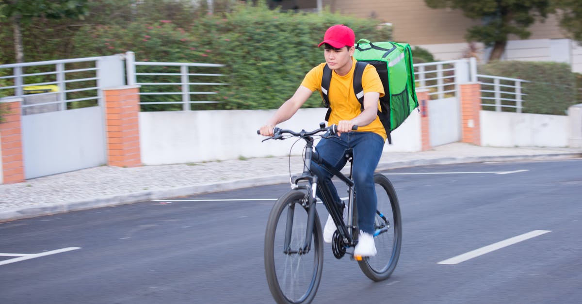 Delivery at Aircraft not available at LAX with Aeroflot? - Man in Green Shirt Riding on Black Bicycle on Road