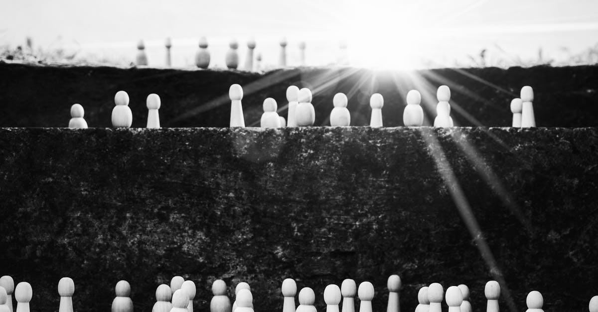 Delta TSA-Precheck status removed - Black and white heap of wooden figurines placed on stairs illustrating social mobility and hierarchy on street with bright sunlight