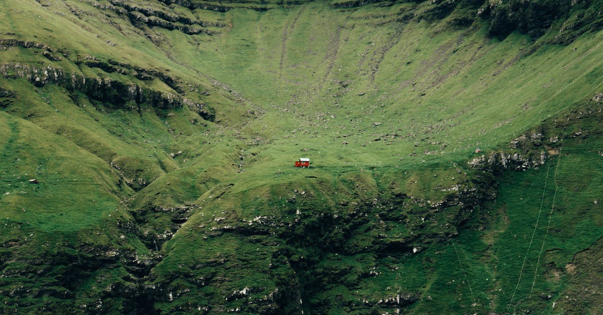 Denmark and Schengen - border controls - Red Car on Road in Between Green Mountains
