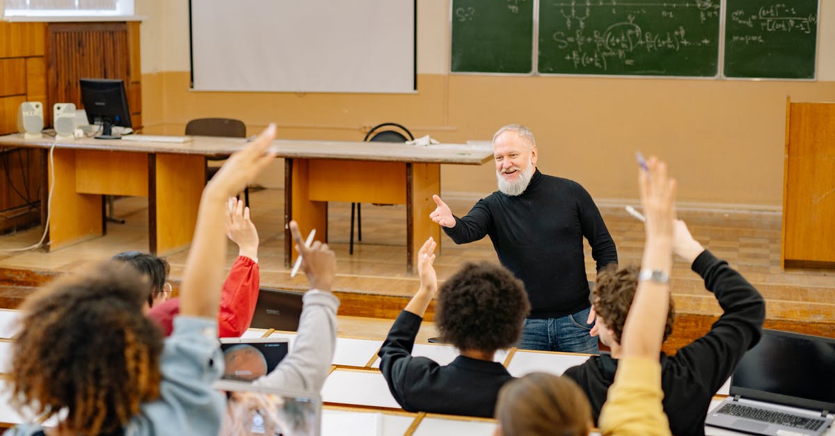 Dependent visa for Masters students in Germany - Man in Black Crew Neck T-shirt Standing in Front of People