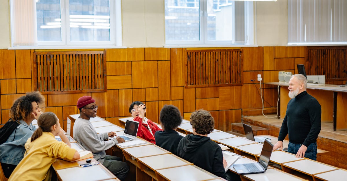 Dependent visa for Masters students in Germany - People Sitting on Chair in Front of Table