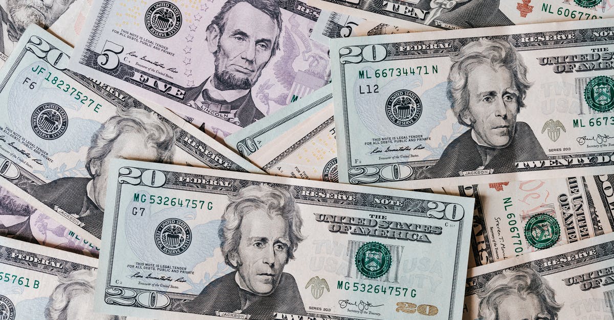 Deported from the US with no stamp; home country said passport was blacklisted - Top view of different types and colors American dollars placed together on each other Deported from the US with no stamp; home country said passport was blacklisted - Top view of different types and colors American dollars placed together on each other