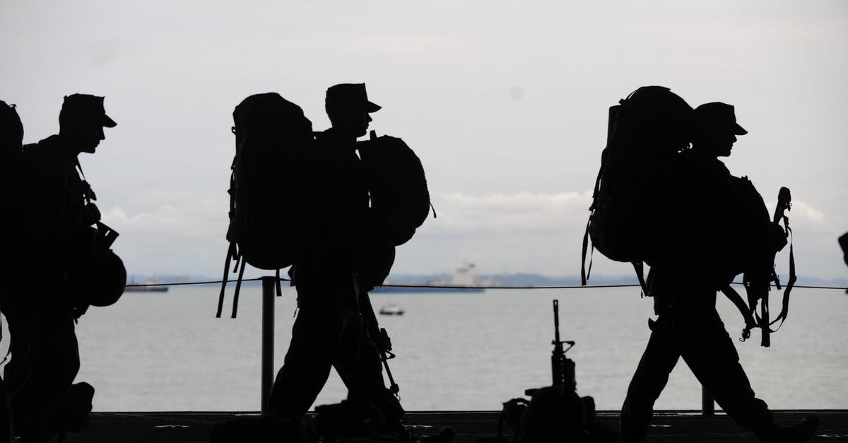 Deported person layovers in the USA? - Silhouette of Soldiers Walking