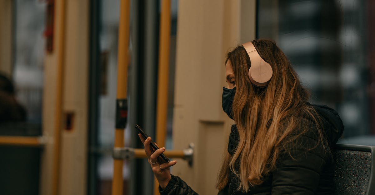 Deutsche Bahn: Reliable wifi on train? - Woman in Black Jacket Holding Smartphone Inside A Train